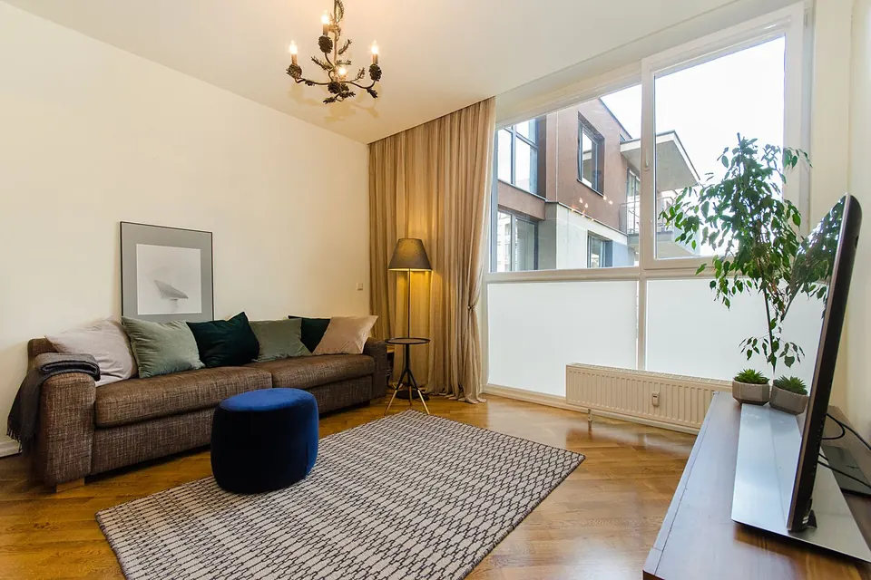 A warm and inviting modern living room with natural light and stylish decor.